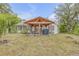 Manicured lawn with covered patio, ideal for outdoor entertaining and relaxing at 801 Canal St, New Smyrna Beach, FL 32168