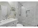 Well-lit bathroom with a glass shower and a white vanity sink with ornate hardware at 801 Canal St, New Smyrna Beach, FL 32168