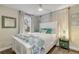 A bright bedroom with wood floors, light walls, a white bed, and a large window at 801 Canal St, New Smyrna Beach, FL 32168