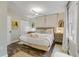 Bedroom with wood-look floors, neutral walls, many windows, and light-colored dressers at 801 Canal St, New Smyrna Beach, FL 32168