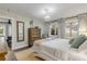 Comfortable bedroom featuring wood-look floors, a chandelier, neutral walls, and many windows at 801 Canal St, New Smyrna Beach, FL 32168
