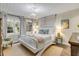 Bright bedroom with white furniture, wood floors, large windows, and a decorative chandelier at 801 Canal St, New Smyrna Beach, FL 32168