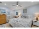 Well-lit bedroom featuring neutral tones, soft bedding, and closet space at 801 Canal St, New Smyrna Beach, FL 32168