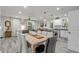 Open concept living area with dining table, kitchen, and living room at 801 Canal St, New Smyrna Beach, FL 32168