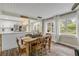 Open dining area with wood table, bright lighting, and a view of the backyard at 801 Canal St, New Smyrna Beach, FL 32168