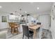 Bright dining area featuring a breakfast bar, a dining table and views into the bedroom at 801 Canal St, New Smyrna Beach, FL 32168