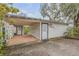 Charming exterior featuring an attached carport and door to the main house at 801 Canal St, New Smyrna Beach, FL 32168