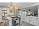 Bright kitchen featuring an island cooktop, white cabinetry, pendant lighting, and eat in seating at 801 Canal St, New Smyrna Beach, FL 32168