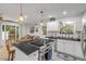 Well-lit kitchen featuring an island, white cabinetry, stainless steel appliances, and natural light at 801 Canal St, New Smyrna Beach, FL 32168