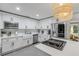 Modern kitchen showcases white cabinets, stainless steel appliances, and a spacious center island cooktop at 801 Canal St, New Smyrna Beach, FL 32168