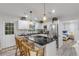 Bright, updated kitchen with black countertops, stainless steel appliances, and decorative lighting fixtures at 801 Canal St, New Smyrna Beach, FL 32168