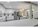 Updated kitchen featuring white cabinets, stainless appliances, and stone countertops at 801 Canal St, New Smyrna Beach, FL 32168