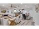 Open-concept living space featuring coastal decor, a modern kitchen, and a dining area with stylish furnishings at 801 Canal St, New Smyrna Beach, FL 32168