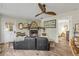 Bright living room features a stone fireplace, ceiling fan, and views to an adjacent bedroom at 801 Canal St, New Smyrna Beach, FL 32168