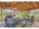 Outdoor patio with a gas grill, ceiling fans, and comfortable seating area at 801 Canal St, New Smyrna Beach, FL 32168
