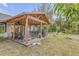 Covered patio area with outdoor dining and seating, perfect for entertaining at 801 Canal St, New Smyrna Beach, FL 32168