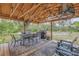 Backyard patio with a gas grill and comfortable seating area at 801 Canal St, New Smyrna Beach, FL 32168