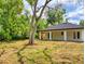 View of backyard of home with a large tree on a sunny day at 808 Rosalia Dr, Sanford, FL 32771