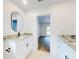 Bright bathroom features dual sinks, modern faucets, granite countertops and an elegant oval mirror at 808 Rosalia Dr, Sanford, FL 32771