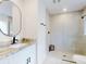 Modern bathroom with a glass shower, sleek fixtures, and stylish round mirror at 808 Rosalia Dr, Sanford, FL 32771