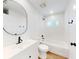Clean bathroom with a modern vanity, tub-shower combo and minimalist decor featuring bronze hardware at 808 Rosalia Dr, Sanford, FL 32771