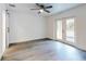 Bedroom featuring double doors to the backyard, a ceiling fan, and sliding barn doors at 808 Rosalia Dr, Sanford, FL 32771