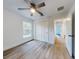 Bright bedroom featuring a ceiling fan, a window, wood grain flooring and a closet at 808 Rosalia Dr, Sanford, FL 32771