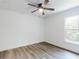 Bright bedroom featuring a ceiling fan, a window, wood grain flooring and white walls at 808 Rosalia Dr, Sanford, FL 32771