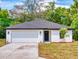 Charming single-story home features a clean white exterior, attached garage, and a neatly landscaped front yard at 808 Rosalia Dr, Sanford, FL 32771