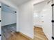 Hallway view reveals a well-lit interior, wood grain flooring, and access to the bathroom and bedroom at 808 Rosalia Dr, Sanford, FL 32771