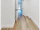 A hallway view exhibits the wood grain flooring, baseboards, and neutral color scheme at 808 Rosalia Dr, Sanford, FL 32771