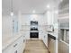 The new kitchen has white cabinetry, stainless appliances, an island, and granite countertops at 808 Rosalia Dr, Sanford, FL 32771