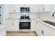 Stylish kitchen with stainless steel appliances, white cabinets, and marble countertops at 808 Rosalia Dr, Sanford, FL 32771