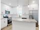 Bright kitchen featuring white cabinets, stainless steel appliances, and a marble countertop island at 808 Rosalia Dr, Sanford, FL 32771