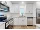 Modern kitchen featuring stainless steel appliances, white cabinets, and stylish fixtures at 808 Rosalia Dr, Sanford, FL 32771