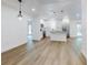 Bright living room with hardwood floors, custom shelving, mini fridge, recessed lighting, and open floor plan at 808 Rosalia Dr, Sanford, FL 32771