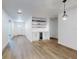 Bright living room with hardwood floors, custom shelving, mini fridge, recessed lighting, and open floor plan at 808 Rosalia Dr, Sanford, FL 32771