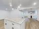 Open living area with marble island, bar area with floating shelves, and modern lighting at 808 Rosalia Dr, Sanford, FL 32771
