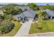 Aerial view of home showcasing the front yard, driveway and landscaping at 1100 Loch Linnhe Ct, New Smyrna Beach, FL 32168