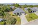 Aerial view of home showcasing the driveway, landscaping, and roof at 1100 Loch Linnhe Ct, New Smyrna Beach, FL 32168