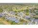 An aerial view shows the community with a golf course, landscaping, and neighborhood at 1100 Loch Linnhe Ct, New Smyrna Beach, FL 32168