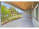 Covered patio overlooking a backyard with trees and a view of neighboring houses at 1100 Loch Linnhe Ct, New Smyrna Beach, FL 32168