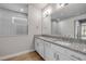 Bright bathroom featuring double vanity sinks and granite countertops at 1100 Loch Linnhe Ct, New Smyrna Beach, FL 32168