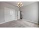 Neutral bedroom featuring plush carpet, a modern chandelier, and a walk in closet at 1100 Loch Linnhe Ct, New Smyrna Beach, FL 32168