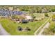 Aerial view of a putting green and clubhouse with parking lot and palm trees on a sunny day at 1100 Loch Linnhe Ct, New Smyrna Beach, FL 32168