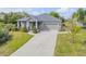 Charming one-story home with gray exterior, manicured landscaping, and a two-car garage at 1100 Loch Linnhe Ct, New Smyrna Beach, FL 32168