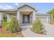 Charming home featuring a covered front porch, stone accents, and manicured landscaping at 1100 Loch Linnhe Ct, New Smyrna Beach, FL 32168