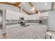 Kitchen with granite island and stainless appliances and attractive wood beam ceiling at 1100 Loch Linnhe Ct, New Smyrna Beach, FL 32168