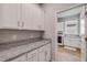 Convenient laundry room features ample cabinet storage and granite countertops at 1100 Loch Linnhe Ct, New Smyrna Beach, FL 32168