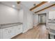 Bright, open living space featuring wood-look floors, beam ceilings, and white trim at 1100 Loch Linnhe Ct, New Smyrna Beach, FL 32168